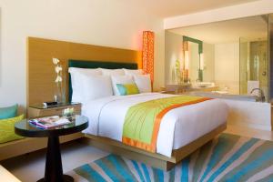 a bedroom with a large bed and a bathroom at Renaissance Phuket Resort & Spa in Mai Khao Beach