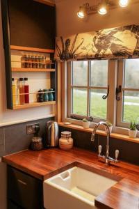 a kitchen with a sink and a counter top at Shepherds Hut in countryside near Bath and Bristol in Bristol