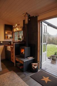 a kitchen with a door open to a kitchen with a stove at Shepherds Hut in countryside near Bath and Bristol in Bristol