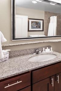 a bathroom with a sink and a large mirror at TownePlace Suites by Marriott Corpus Christi in Corpus Christi