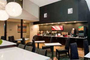 a restaurant with tables and chairs and a bar at Residence Inn by Marriott Spartanburg in Spartanburg