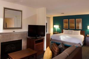 a hotel room with a bed and a television at Residence Inn by Marriott Spartanburg in Spartanburg