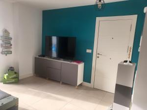 a living room with a flat screen tv on a wall at Buddha house in Torrox Costa