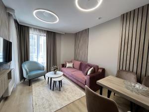 a living room with a couch and a table at Inter Holiday Apartments in Pomorie