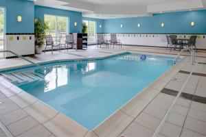 a large pool with blue water in a hotel room at Fairfield Inn and Suites by Marriott Seymour in Seymour