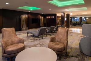 a waiting room with chairs and a table at Courtyard by Marriott Victorville Hesperia in Hesperia