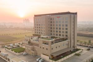 a rendering of a hotel building with the sunset in the background at Courtyard by Marriott Surat in Surat
