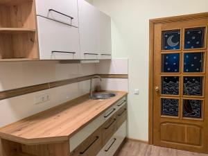 a kitchen with a sink and a wooden counter at Green house Ramuciai in Ramučiai +4 photos