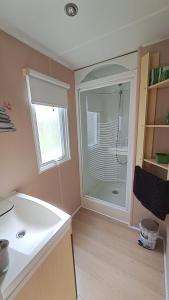a bathroom with a shower with a glass door at Muntagn' home in Corte +28 photos