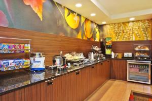 a restaurant kitchen with a counter with food at Fairfield by Marriott Southeast Hammond, IN in Hammond