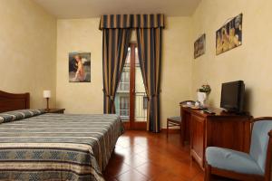 Postel nebo postele na pokoji v ubytování Hotel Bologna