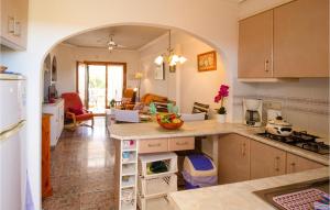 a kitchen with an archway in the middle of a room at Nice Apartment In Guardamar Del Segura With Kitchen in Guardamar del Segura