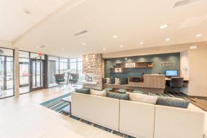 a living room with a couch and a tv at Fairfield Inn & Suites by Marriott Des Moines Altoona in Altoona