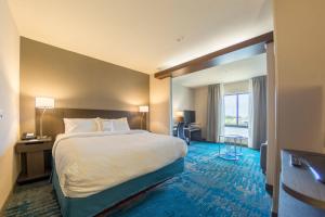 a hotel room with a large bed and a window at Fairfield Inn & Suites by Marriott Des Moines Altoona in Altoona