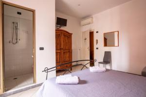 Postel nebo postele na pokoji v ubytování Hotel Paolina