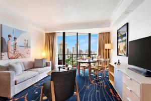 a living room with a couch and a table with a television at Marriott Vacation Club at Surfers Paradise in Gold Coast