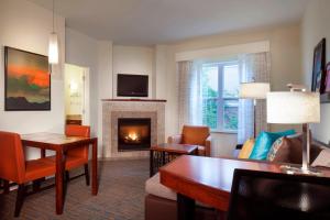 a living room with a fireplace and a couch at Residence Inn by Marriott Stillwater in Stillwater