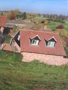 a house with a red roof and two windows at Suffolk View Apartment in Tuddenham