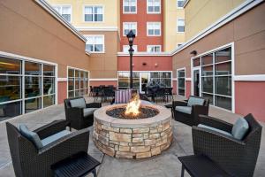 a courtyard with a fire pit in a building at Residence Inn by Marriott Stillwater in Stillwater