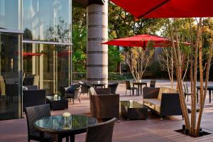 a patio with tables and chairs and a red umbrella at Tokyo Marriott Hotel in Tokyo
