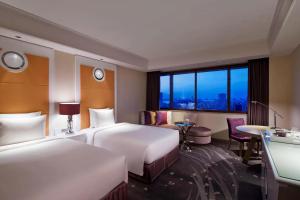 a hotel room with two beds and a window at Tokyo Marriott Hotel in Tokyo