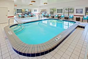 a large swimming pool in a hotel lobby at Residence Inn Merrillville in Merrillville