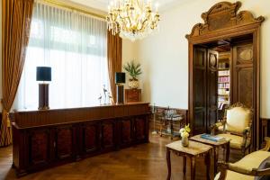 a living room with a chandelier and a large room at Schloss Lieser, Autograph Collection in Lieser