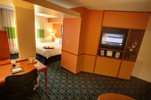 a hotel room with a bed and a television at Fairfield Inn & Suites Mount Vernon Rend Lake in Mount Vernon