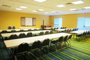 a conference room with tables and chairs and a whiteboard at Fairfield Inn & Suites Mount Vernon Rend Lake in Mount Vernon