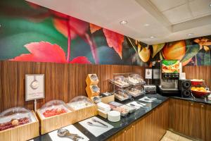 a restaurant with a counter with food on it at Fairfield Inn & Suites Christiansburg in Christiansburg