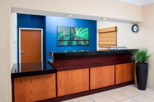 a lobby with a reception desk with a blue wall at Fairfield Inn Middletown Monroe in Middletown