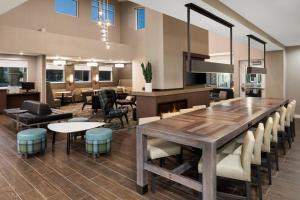uma sala de jantar com uma grande mesa de madeira e cadeiras em Residence Inn by Marriott East Peoria em Peoria