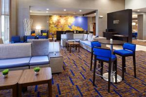 a lobby with couches and chairs and tables at Courtyard Kansas City Overland Park / Convention Center in Overland Park