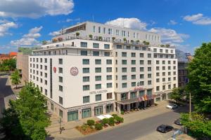 a white building with flowers on the top of it at Sheraton Carlton Nuernberg in Nuremberg