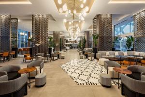 a lobby of a hotel with tables and chairs at Rabat Marriott Hotel in Rabat