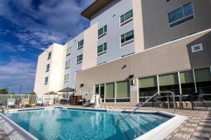 a swimming pool in front of a hotel at TownePlace Suites by Marriott Conroe in Conroe