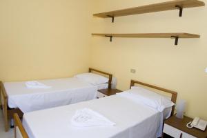 Postel nebo postele na pokoji v ubytování Hotel Rosa Dei Venti