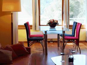 a living room with a table with chairs and a couch at Sportpension Aichholzer in Oberaichwald
