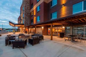 a patio with chairs and tables outside of a building at TownePlace Suites by Marriott Lexington Keeneland/Airport in Lexington