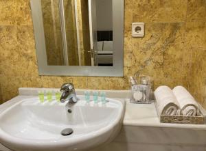 un lavandino bianco in un bagno con uno specchio di Elegant Suite a Siviglia