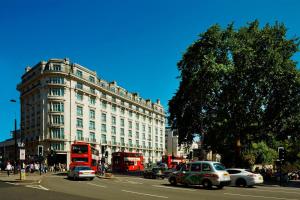 a busy city street with cars and buses at London Marriott Hotel Park Lane in London