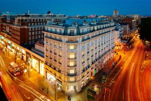 a large white building on a city street at night at London Marriott Hotel Park Lane in London