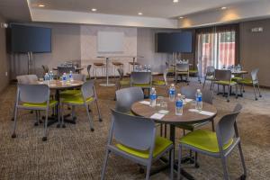 a conference room with tables and chairs with water bottles on them at SpringHill Suites Herndon Reston in Herndon