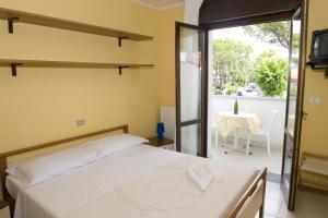 Postel nebo postele na pokoji v ubytování Hotel Rosa Dei Venti + 19 fotografií