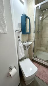 a bathroom with a toilet and a sink and a shower at Millfields Place in London