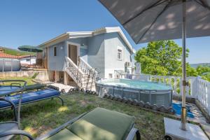 a backyard with a swimming pool and a house at Holiday Home Marina in Zagorje
