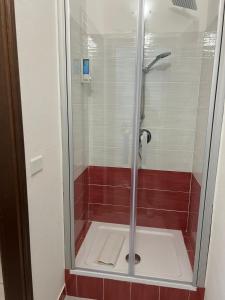 a shower with a glass door in a bathroom at Your home outlet 4 in Serravalle Scrivia