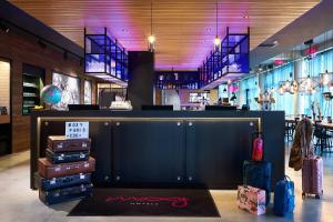 un deposito con un mucchio di bagagli in una stanza di Moxy Paris Charles de Gaulle Airport a Roissy en France