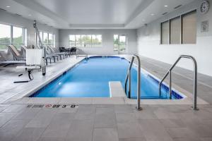 a large swimming pool in a building with a waiting room at TownePlace Suites by Marriott Madison West, Middleton in Madison