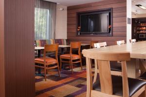 a dining room with a table and chairs and a tv at Fairfield Inn Greenville Spartanburg Airport in Greenville